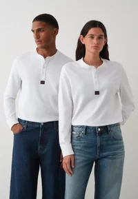White Calvin Klein Jeans Henley long-sleeve T-shirt worn by two models, front view