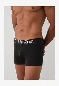 Black Calvin Klein trunks worn by model, front detail