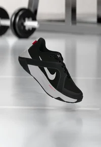 Nike Hybrid black and white training shoe in a gym setting