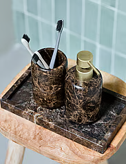 House Doctor brown marble soap dispenser styled with bathroom accessories