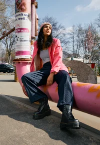 Dr. Martens Jadon boots worn with jeans and a pink jacket