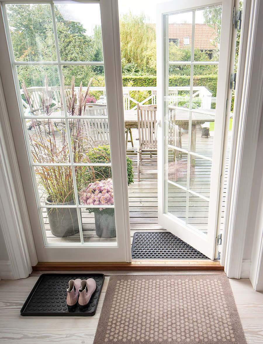 Sand/Beige Dot floor mat beside a terrace entrance