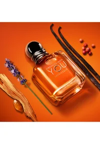 Armani Stronger With You Intensely fragrance bottle on an orange background