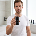 Man holding Armani Code deodorant during a morning routine