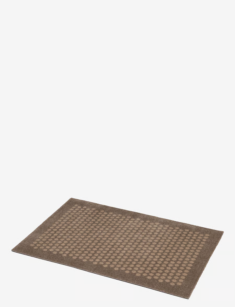 Sand/Beige dotted floor mat, angled view